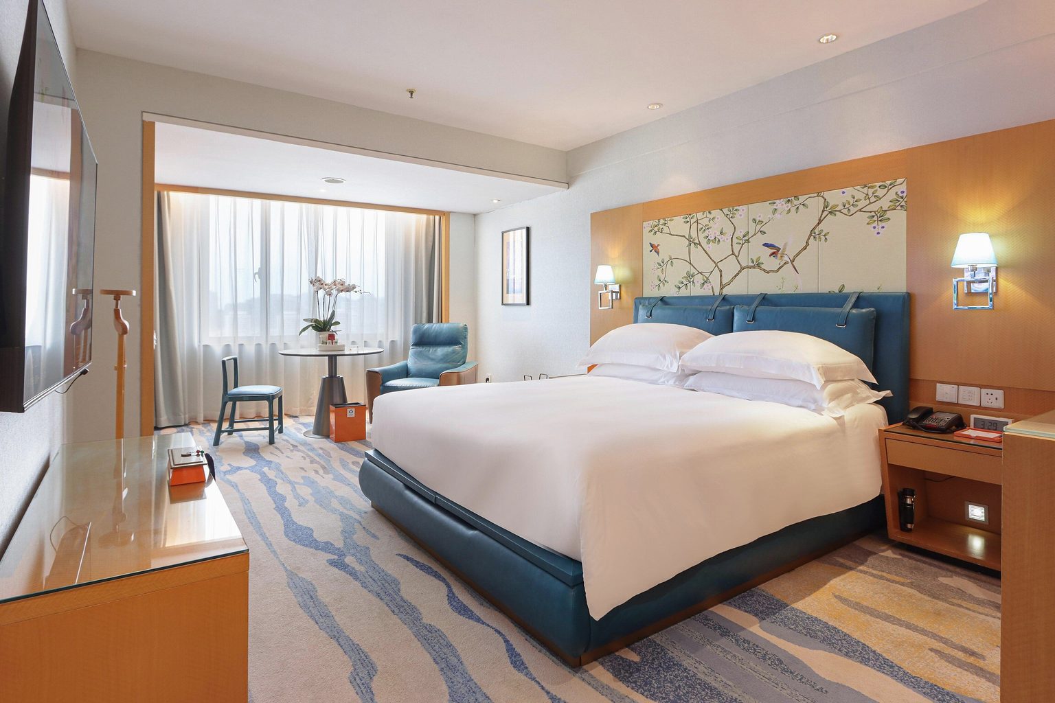 Premium Room with a king bed, a decorative headboard panel, an armchair and a window seating area